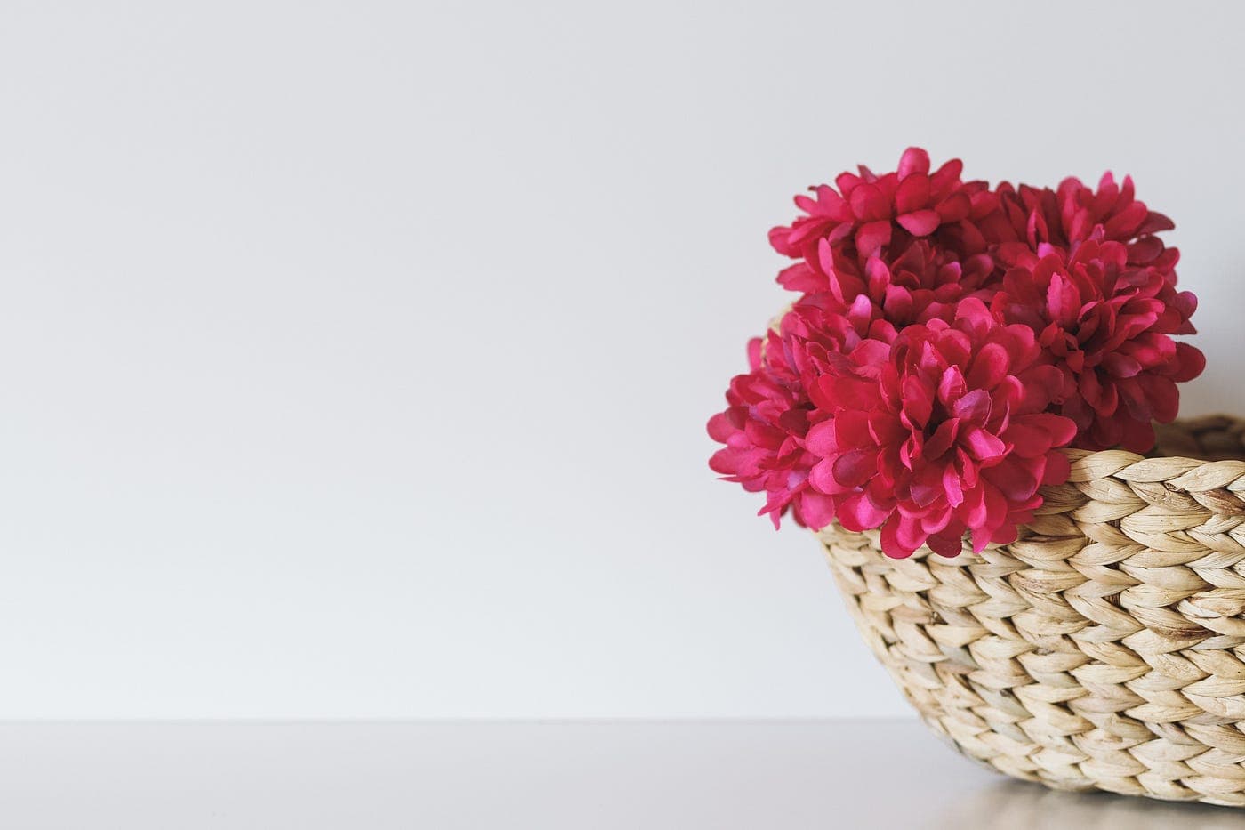 bouquet of flowers next to a straw basket
